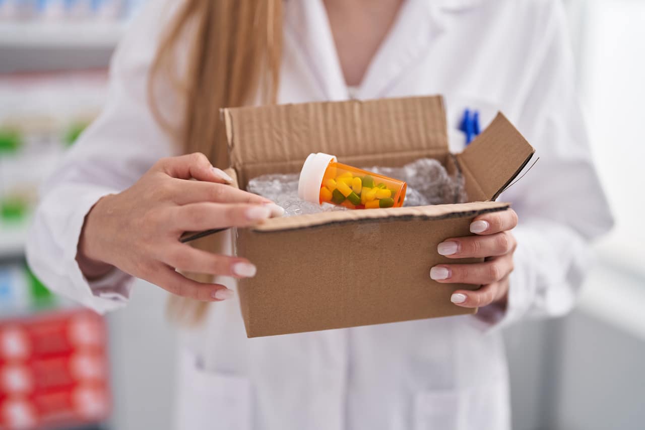 woman holding box of medications